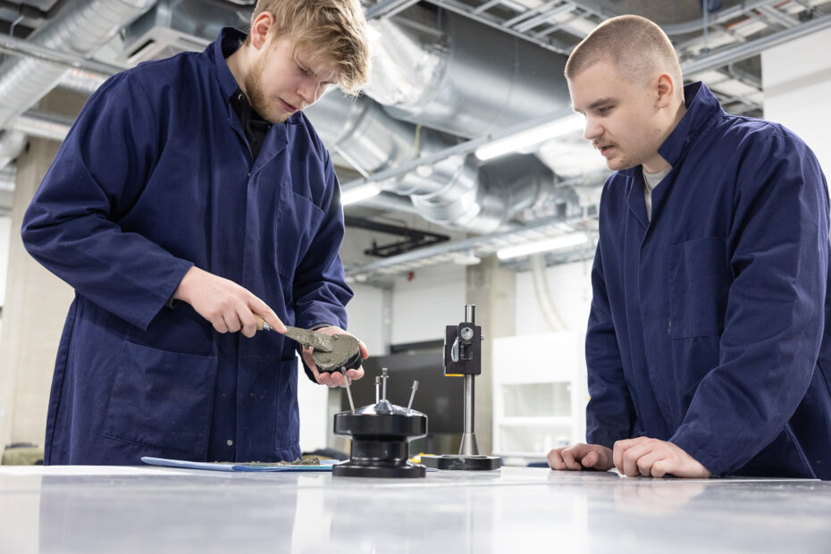 two students in blue work overalls