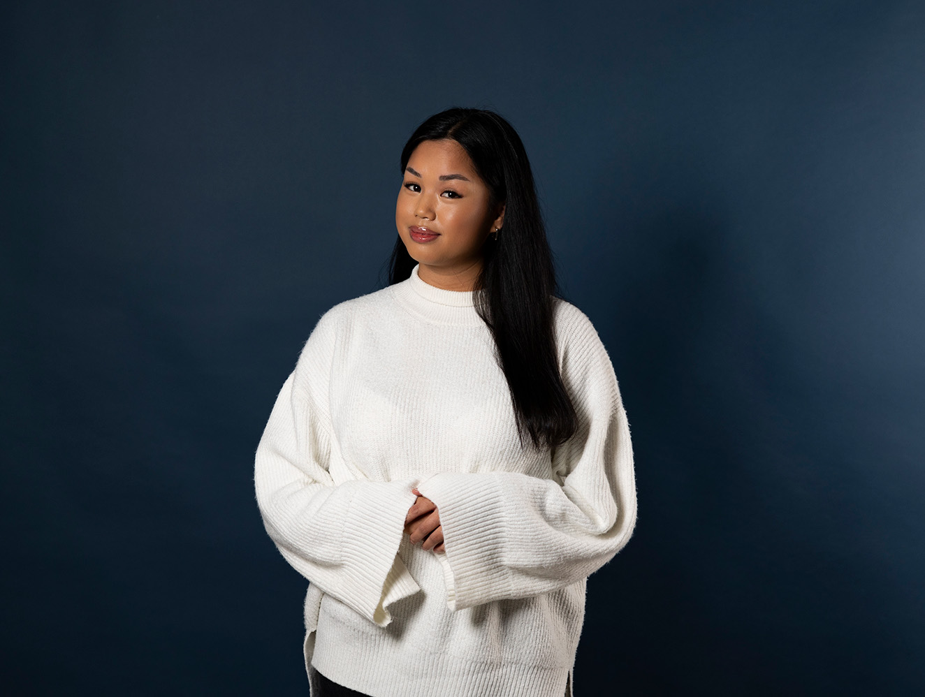 Person in front of a dark blue background