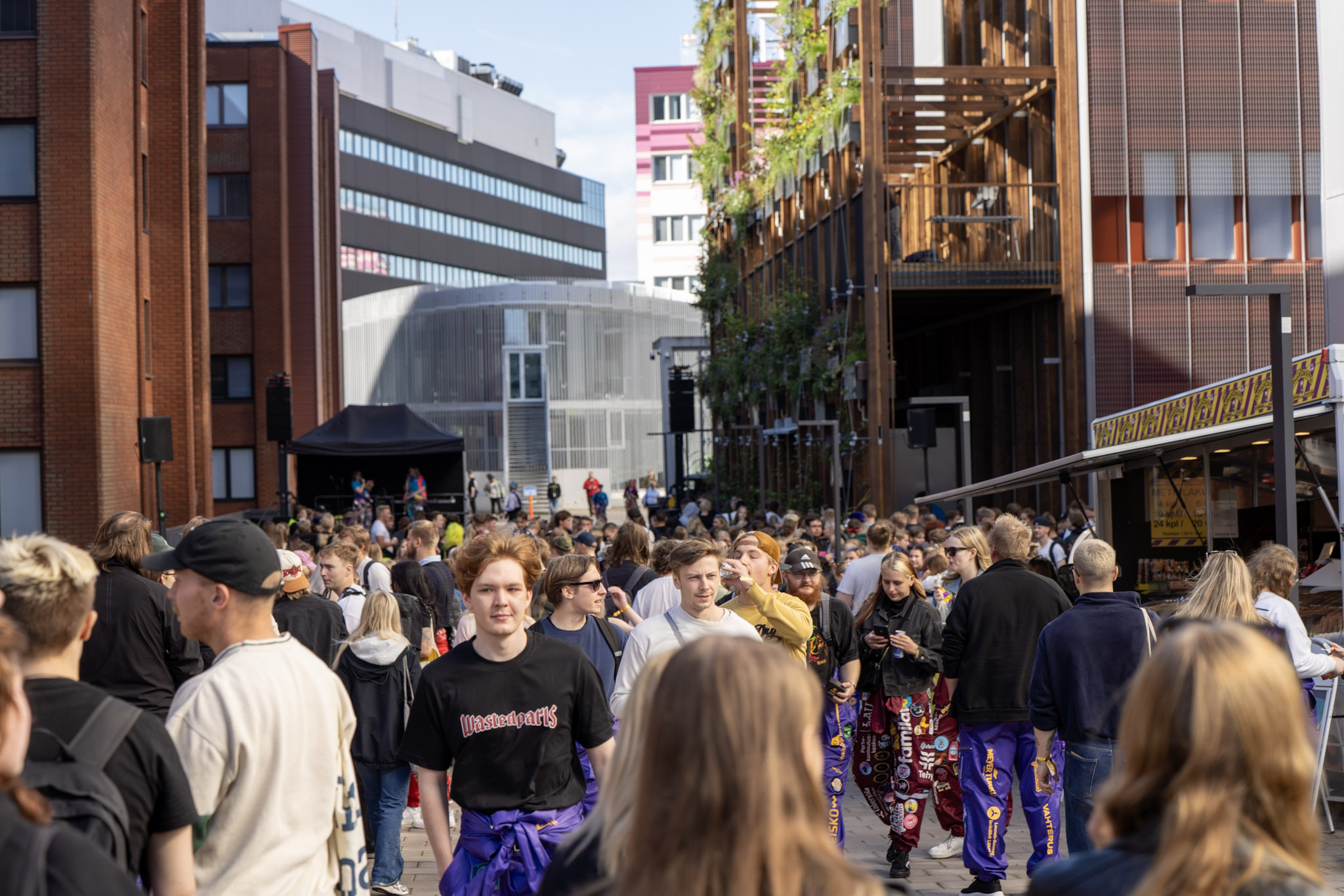 Ihmisvilinää aukiolla, osa pukeutunut opiskelijahaalareihin