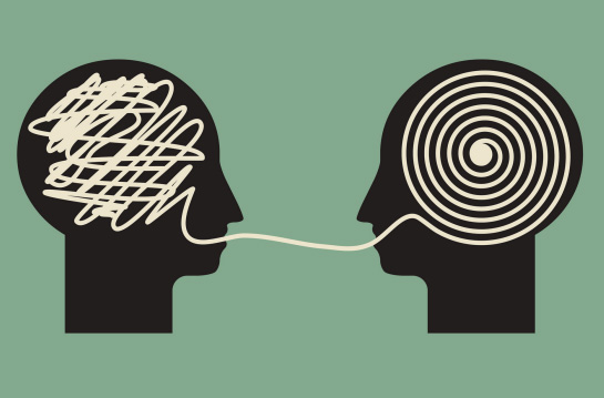 Piirroskuva: kaksi mustaa päätä vastakkain, keltaisella viivalla toisessa sikin sokin, toisessa ympyrässä sisäkkäin.